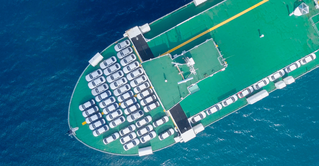 Car carrier ship with imported automobiles demonstrating the benefit of shipping heavy items by sea transportation.